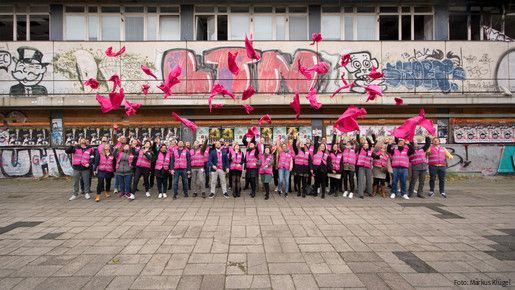 Investition in den öffentlichen Dienst Junge Beschäftigte des öffentlichen Dienstes vor einem leerstehenden, heruntergekommenen Gebäude